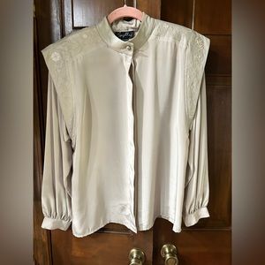 Blouse with faux leather.